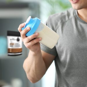 Man holding protein shake with hemp protein in the background